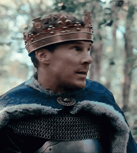 Man Wearing Crown And Chain Mail Looking Right GIF