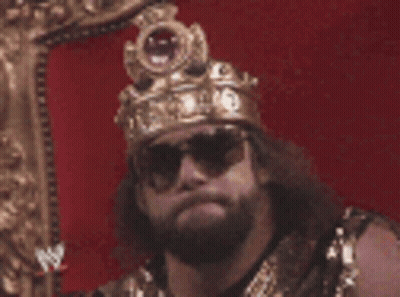 Man Wearing Crown And Sunglasses Sitting In Chair GIF