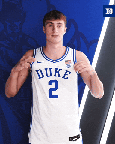 Man Wearing Duke Jersey Holding Up Jersey GIF
