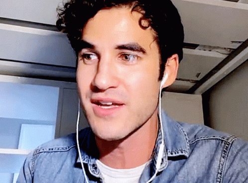 Man Wearing Ear Buds And Denim Shirt GIF