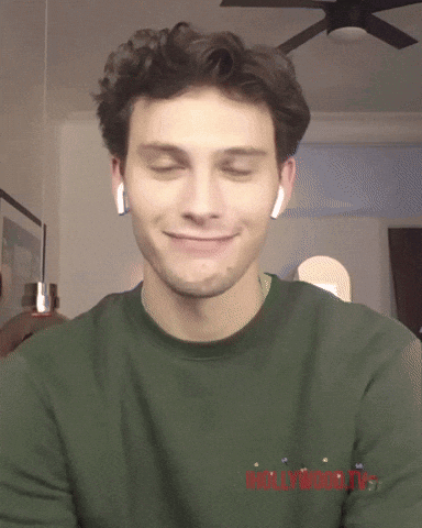 Man Wearing Ear Buds And Green Shirt Saying Hollywood GIF