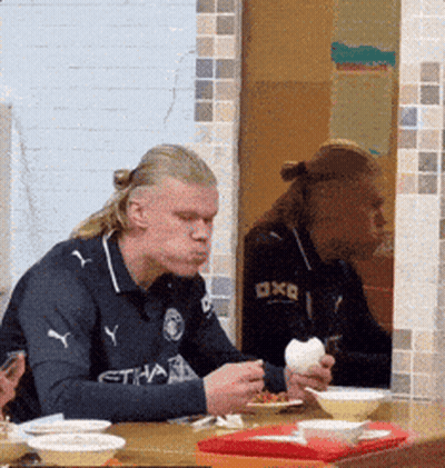 Man Wearing Etihad Shirt Eating GIF