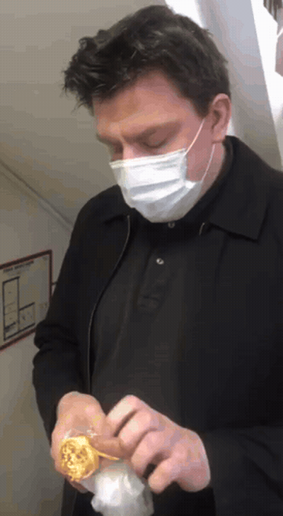 Man Wearing Face Mask Holding Donut GIF