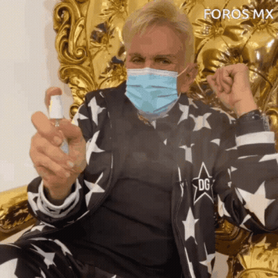Man Wearing Face Mask Holding Spray Bottle GIF