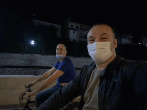 Man Wearing Face Mask Riding Bike GIF