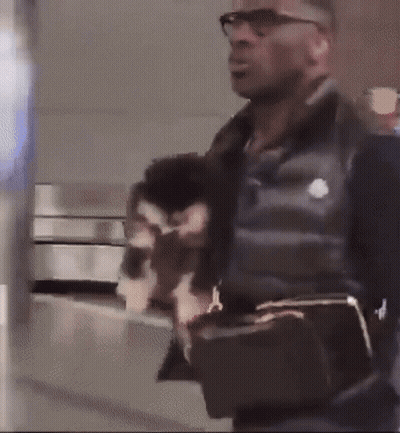 Man Wearing Glasses And Black Vest Holding Purse GIF