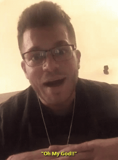 Man Wearing Glasses And Earbuds Saying Oh My God GIF