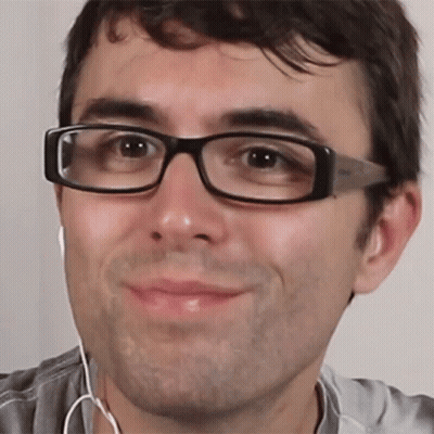 Man Wearing Glasses And Earbuds Smiling GIF