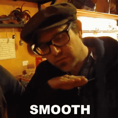Man Wearing Glasses And Flat Cap Holding Something GIF