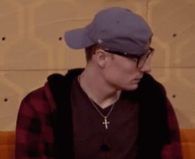 Man Wearing Glasses And Hat Sitting GIF