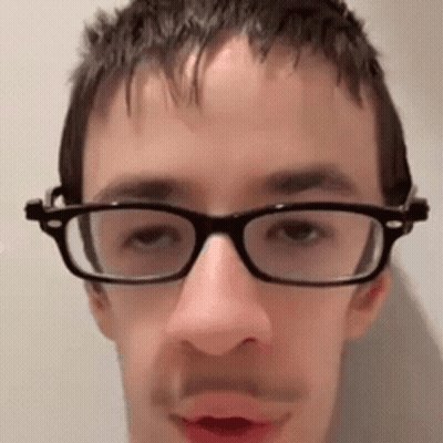 Man Wearing Glasses And Mustache Looking At Camera GIF