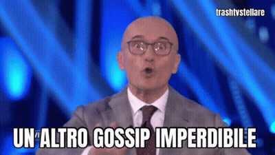 Man Wearing Glasses And Suit Says Un Altro Gossip Imperdibile GIF
