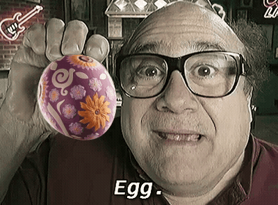 Man Wearing Glasses Holding Purple Easter Egg GIF