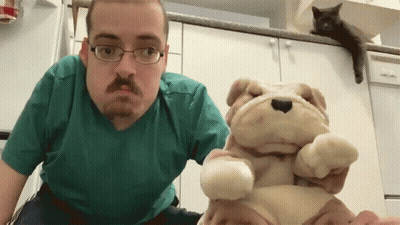 Man Wearing Glasses Holding Stuffed Dog