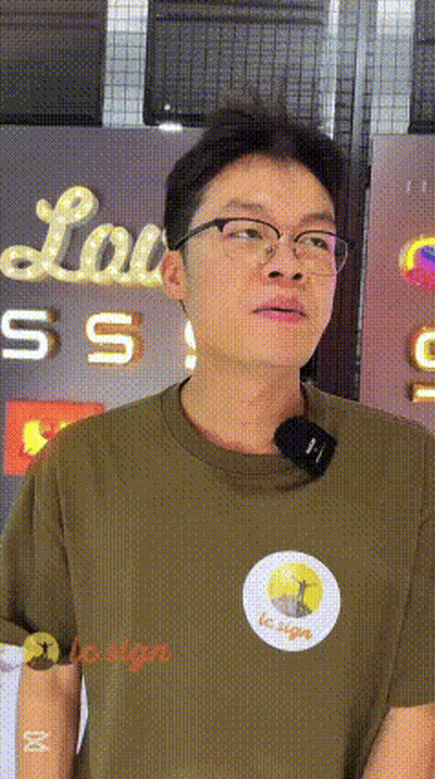 Man Wearing Glasses In Front Of Lou Sign GIF