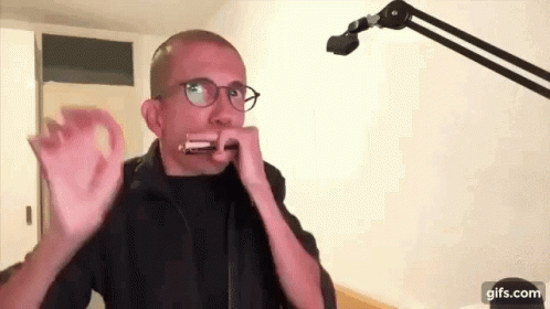 Man Wearing Glasses Playing Harmonica GIF