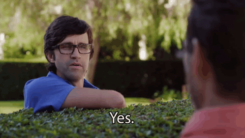 Man Wearing Glasses Says Yes While Sitting In Bush GIF