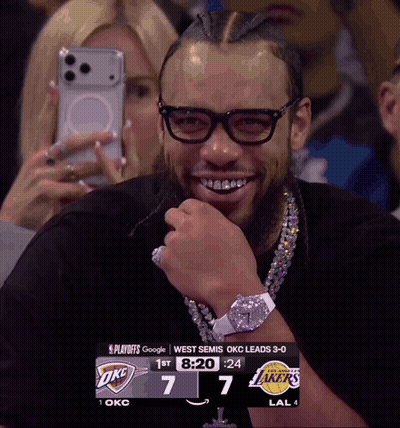 Man Wearing Glasses Smiling At Scoreboard GIF
