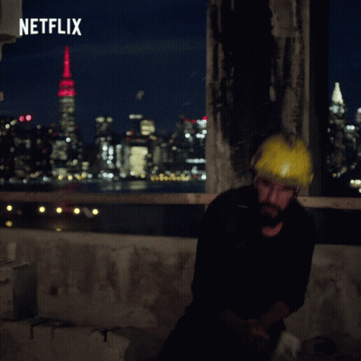 Man Wearing Hard Hat In Front Of Netflix Ad GIF
