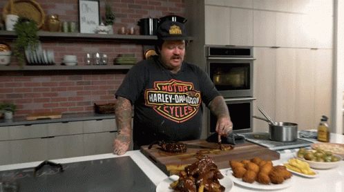 Man Wearing Harley Davidson T-Shirt Cutting Meat GIF
