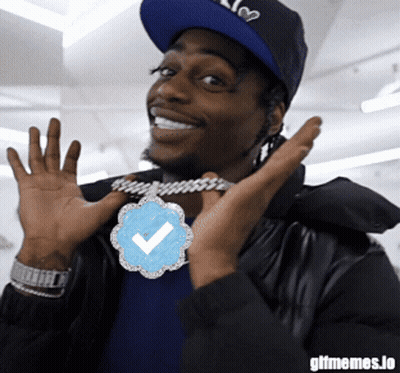 Man Wearing Hat And Check Mark Necklace GIF