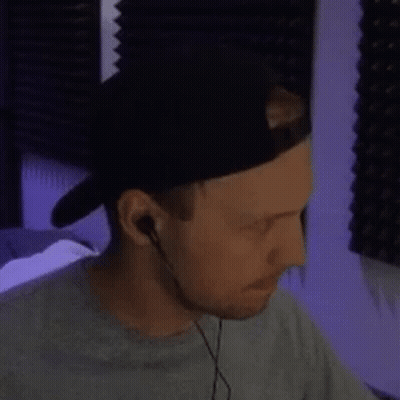 Man Wearing Hat And Earbuds Looking Down GIF