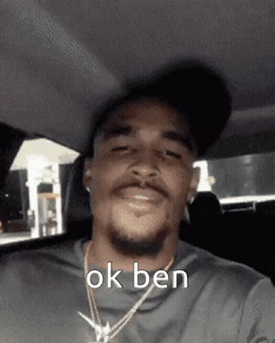 Man Wearing Hat And Necklace In Car GIF