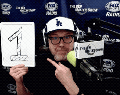 Man Wearing Hat Holding Number One Sign GIF
