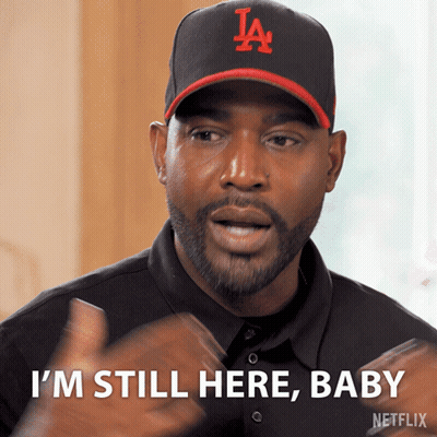 Man Wearing Hat Saying I'm Still Here Baby GIF