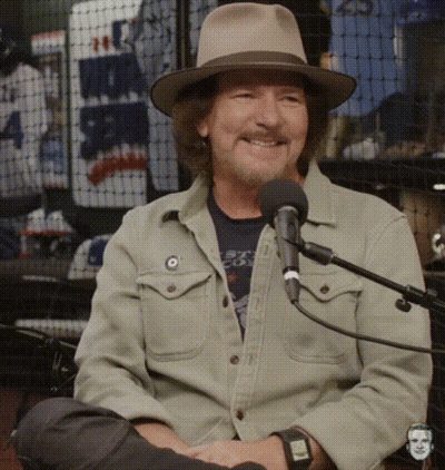Man Wearing Hat Sitting At Microphone GIF