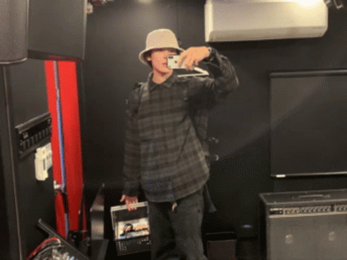 Man Wearing Hat Takes Picture Of Himself In Mirror GIF
