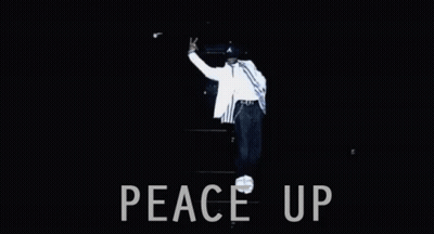 Man Wearing Hat With Letter A In Front Of A Town Down GIF