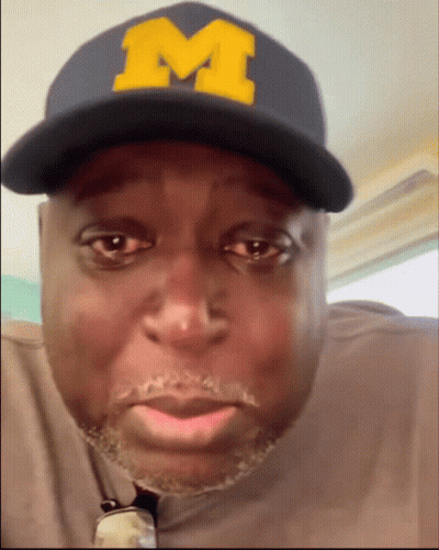 Man Wearing Hat With Yellow M GIF