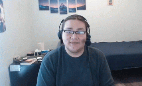 Man Wearing Headphones And Glasses Sitting In Room GIF