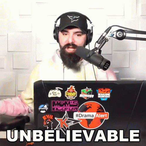 Man Wearing Headphones And Hat In Front Of Laptop With #Dramaalert Sticker GIF