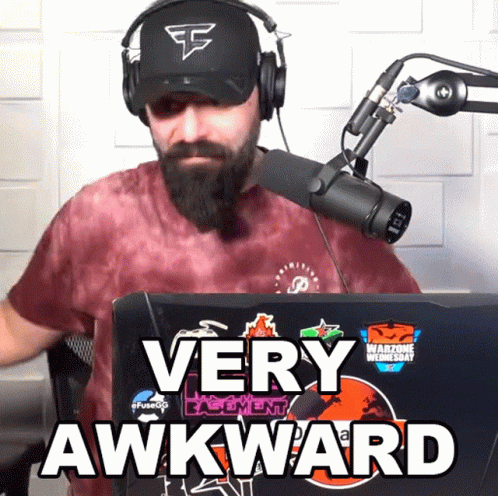 Man Wearing Headphones And Hat Says Very Awkward In Front Of Microphone GIF