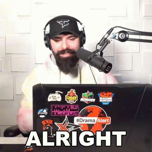 Man Wearing Headphones And Hat Sitting In Front Of Laptop Saying Alright GIF
