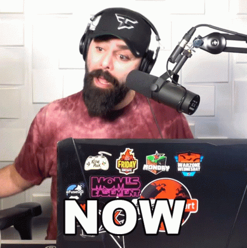 Man Wearing Headphones And Hat Stands In Front Of Laptop Saying Now GIF