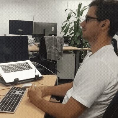 Man Wearing Headphones At Desk GIF