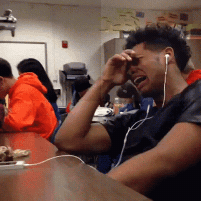 Man Wearing Headphones Crying In Classroom GIF