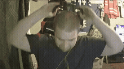 Man Wearing Headphones Holding Head GIF