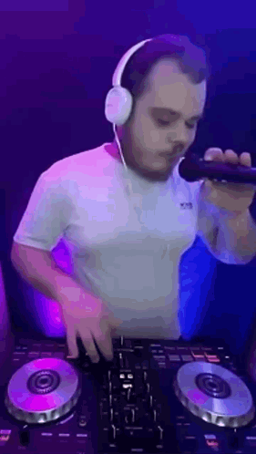 Man Wearing Headphones Holding Microphone At DJ Controller GIF