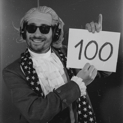 Man Wearing Headphones Holding Sign With 100 GIF