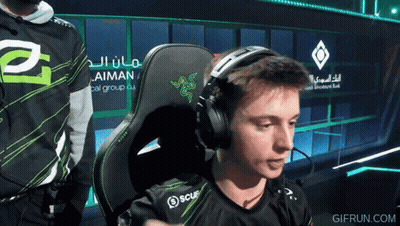 Man Wearing Headphones In Front Of Aiman Sign GIF