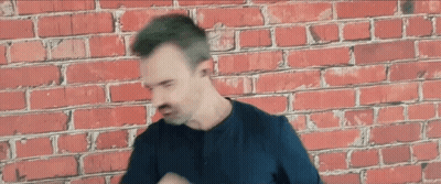 Man Wearing Headphones In Front Of Brick Wall GIF
