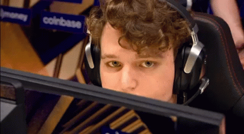 Man Wearing Headphones In Front Of Coinbase Sign GIF