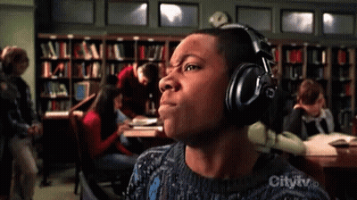 Man Wearing Headphones In Library With City TV Logo GIF