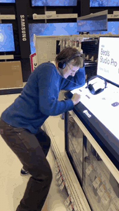 Man Wearing Headphones Looking at Beats Studio Pro
