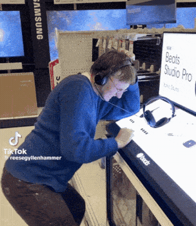 Man Wearing Headphones Looking At Beats Studio Pro Display GIF