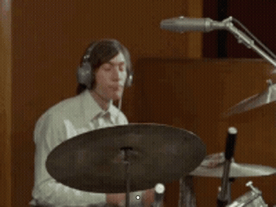 Man Wearing Headphones Playing Drum Set In Recording Studio GIF